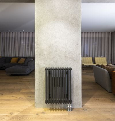 Living room with coloured column radiator Purmo in reference project Barault Architects